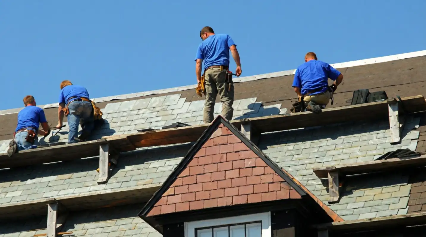 Roof replacement in progress with a team of professional contractors installing new shingles on a residential home in Las Vegas, NV